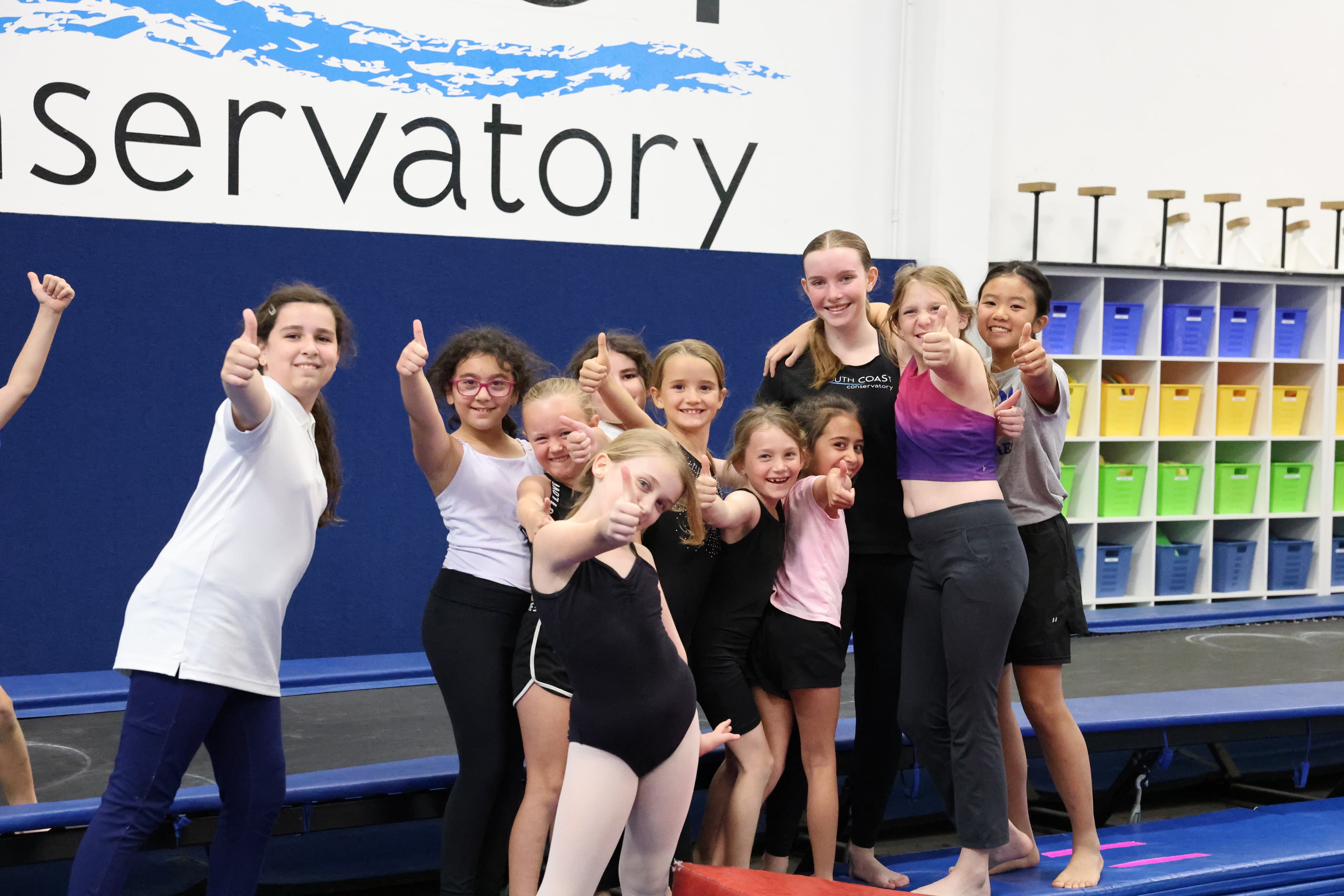 Dance students and instructors celebrating together in the studio